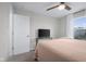 Neutral bedroom featuring a TV, a ceiling fan, and large window with natural light at 2736 Victory Dr, Columbus, IN 47203