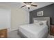 Neutral bedroom featuring a ceiling fan, decorative accent wall, carpet, and end table at 2736 Victory Dr, Columbus, IN 47203