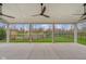 Spacious covered patio with overhead fans offering serene views of the well-maintained backyard and pond at 2736 Victory Dr, Columbus, IN 47203