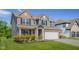 Stunning two-story home with brick and gray siding, manicured lawn, and attached three-car garage at 2736 Victory Dr, Columbus, IN 47203