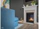 Living room detail featuring a modern fireplace with an ornate mantle and a contemporary dark gray accent wall at 2736 Victory Dr, Columbus, IN 47203
