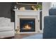 Close-up of a modern fireplace with a white mantel and decorative accents at 2736 Victory Dr, Columbus, IN 47203
