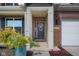 Charming front door with decorative wreath and sidelights, accented by brick and fresh landscaping at 2736 Victory Dr, Columbus, IN 47203