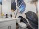 Chic half bath with bold floral wallpaper and sleek fixtures offers a modern and stylish design at 2736 Victory Dr, Columbus, IN 47203