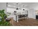 Large open concept kitchen with island, bar stool seating, stainless steel appliances and hardwood floors at 2736 Victory Dr, Columbus, IN 47203