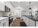 Bright kitchen with stainless steel appliances, white cabinets, and a large island at 2736 Victory Dr, Columbus, IN 47203