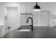 Modern kitchen island with a black sink, faucet, and ample counter space at 2736 Victory Dr, Columbus, IN 47203