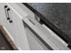 Close up image of a modern stainless steel Samsung dishwasher with white cabinets and dark countertops in the background at 2736 Victory Dr, Columbus, IN 47203