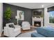 Inviting living room with a cozy fireplace and stylish white armchairs at 2736 Victory Dr, Columbus, IN 47203