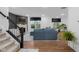 Bright living room with hardwood floors, fireplace, and a large blue sectional, perfect for entertaining at 2736 Victory Dr, Columbus, IN 47203