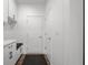 Clean mudroom features white cabinets, bench, and dark floors for a stylish and organized entryway at 2736 Victory Dr, Columbus, IN 47203