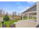 Covered outdoor patio overlooking a lush backyard and scenic pond, perfect for entertaining and relaxation at 2736 Victory Dr, Columbus, IN 47203