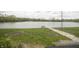 Scenic backyard view with a stone path leading to a private lake dock at 3004 Lake Shore Dr # E, Indianapolis, IN 46205