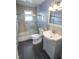 Tiled bathroom featuring a large vanity, toilet, and tiled shower at 3004 Lake Shore Dr # E, Indianapolis, IN 46205