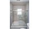 Updated bathroom featuring a tiled shower with sliding doors and window at 3004 Lake Shore Dr # E, Indianapolis, IN 46205