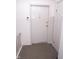 Classic white apartment front door with a doorbell and gold accents at 3004 Lake Shore Dr # E, Indianapolis, IN 46205
