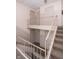Well-maintained staircase with metal railings in a building hallway at 3004 Lake Shore Dr # E, Indianapolis, IN 46205