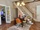 Inviting dining area featuring hardwood floors and a staircase with brick accent wall at 323 E Adams St, Franklin, IN 46131