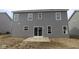 Spacious backyard featuring a concrete patio and gray siding at 3941 Highcrest Rd, Indianapolis, IN 46239