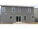 This backyard features gray siding and sliding glass doors to backyard patio at 3941 Highcrest Rd, Indianapolis, IN 46239