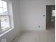 This bedroom offers a large window for natural lighting and an entry leading to the rest of the home at 3941 Highcrest Rd, Indianapolis, IN 46239