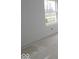 Bright, unfinished bedroom with freshly painted white walls and baseboards; a single window allows for plenty of natural light at 3941 Highcrest Rd, Indianapolis, IN 46239