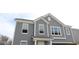 Elegant two-story home featuring gray siding, white trim, and large windows at 3941 Highcrest Rd, Indianapolis, IN 46239