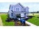 Charming two-story home with covered porch, manicured lawn, and professional landscaping at 3941 Highcrest Rd, Indianapolis, IN 46239