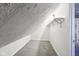 Angled white attic space with carpet and shelf at 422 N Oxford St, Indianapolis, IN 46201