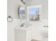 Bathroom featuring white vanity, wainscoting, and a view outside the window at 422 N Oxford St, Indianapolis, IN 46201