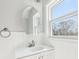 Bright bathroom features a modern vanity with an oval mirror and natural light from the window at 422 N Oxford St, Indianapolis, IN 46201