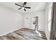 Bright bedroom with new floors, modern ceiling fan, and natural light from the window at 422 N Oxford St, Indianapolis, IN 46201