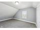 Bedroom featuring neutral walls, gray carpeting, and a window with blinds at 422 N Oxford St, Indianapolis, IN 46201