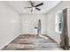 Bright bedroom with new floors, modern ceiling fan, and natural light from the window at 422 N Oxford St, Indianapolis, IN 46201