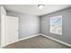 Bedroom featuring neutral walls, gray carpeting, and a window with blinds at 422 N Oxford St, Indianapolis, IN 46201