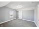 A bright bedroom featuring neutral walls, grey carpeting, and a window at 422 N Oxford St, Indianapolis, IN 46201