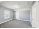 A bright bedroom featuring neutral walls, grey carpeting, and a window at 422 N Oxford St, Indianapolis, IN 46201