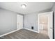 A bright bedroom featuring neutral walls, grey carpeting, and an open doorway at 422 N Oxford St, Indianapolis, IN 46201