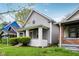 A charming house with gray siding, a covered porch and a well-kept lawn at 422 N Oxford St, Indianapolis, IN 46201