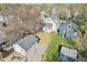 Aerial view of a well-kept two-story home with a detached garage and a gravel parking area at 422 N Oxford St, Indianapolis, IN 46201