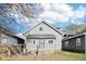 Charming two-story home with gray siding, a gabled roof, and a well-maintained front yard at 422 N Oxford St, Indianapolis, IN 46201