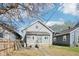 Charming home with gray siding, a small front yard, and mature trees enhancing curb appeal at 422 N Oxford St, Indianapolis, IN 46201