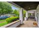 The spacious covered porch provides a relaxing spot with views of the neighborhood at 422 N Oxford St, Indianapolis, IN 46201