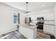 This kitchen boasts an island, stainless steel appliances, and white cabinetry at 422 N Oxford St, Indianapolis, IN 46201