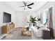 Bright living room featuring hardwood floors, stylish furnishings, and a modern ceiling fan at 422 N Oxford St, Indianapolis, IN 46201