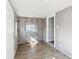 Updated sunroom with wood floors, paneled walls, and storage cabinets at 422 N Oxford St, Indianapolis, IN 46201