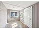 Enclosed sunroom with natural light, neutral color palette, and new wood flooring at 422 N Oxford St, Indianapolis, IN 46201