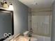 Bathroom featuring a shower-tub combo, vanity with sink and dark framed mirror at 480 Village Blvd, Mooresville, IN 46158