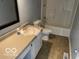 Bathroom with a vanity and toilet next to a tub with shower, and neutral colored floors at 480 Village Blvd, Mooresville, IN 46158