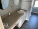 Bathroom featuring double sinks, vanity, and vinyl flooring at 480 Village Blvd, Mooresville, IN 46158